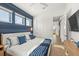 King bedroom with blue accent wall and private access to balcony at 112 Maple Ave, Anna Maria, FL 34216