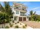Two-story home with modern design, two-car garage, and landscaped front yard at 112 Maple Ave, Anna Maria, FL 34216