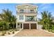 Two-story home with white exterior, brown garage doors, and a paved driveway at 112 Maple Ave, Anna Maria, FL 34216