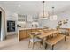 Modern kitchen with white cabinets, quartz countertops, and a large island at 112 Maple Ave, Anna Maria, FL 34216