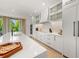 Modern kitchen with white cabinets, quartz countertops, and a large island at 112 Maple Ave, Anna Maria, FL 34216