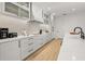 Modern kitchen with white cabinets, quartz countertops, and a large island at 112 Maple Ave, Anna Maria, FL 34216