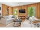 Bright living room with comfy sofas, a coffee table, and built-in shelving at 112 Maple Ave, Anna Maria, FL 34216