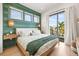 Main bedroom with green accent wall and private balcony access at 112 Maple Ave, Anna Maria, FL 34216