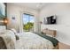Main bedroom with private balcony access and large TV at 112 Maple Ave, Anna Maria, FL 34216