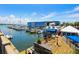 Waterfront marina with boats docked, offering a vibrant, sunny atmosphere at 112 Maple Ave, Anna Maria, FL 34216