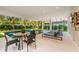 Modern pool and patio with lounge chairs and dining table at 112 Maple Ave, Anna Maria, FL 34216