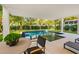 Stunning pool with patio furniture and tropical plants at 112 Maple Ave, Anna Maria, FL 34216