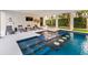 Luxury pool with swim up bar and lounge area at 112 Maple Ave, Anna Maria, FL 34216