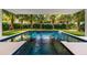 Inviting pool with a swim-up bar and lush landscaping at 112 Maple Ave, Anna Maria, FL 34216