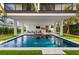 Expansive pool with covered patio and lounge area at 112 Maple Ave, Anna Maria, FL 34216