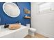 Stylish powder room with wood vessel sink and marble vanity at 112 Maple Ave, Anna Maria, FL 34216