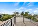 Rooftop deck with ocean view and metal railing at 112 Maple Ave, Anna Maria, FL 34216