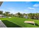 Rooftop deck with artificial turf and cornhole games at 112 Maple Ave, Anna Maria, FL 34216