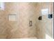 Spa-like shower with beige chevron tile and glass enclosure at 112 Maple Ave, Anna Maria, FL 34216