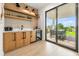 Wet bar with wood cabinets and beverage fridge at 112 Maple Ave, Anna Maria, FL 34216