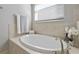 Relaxing bathroom with an oval-shaped soaking tub at 11550 Blackfin St, Venice, FL 34292