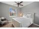Bright bedroom with a queen-size bed and ceiling fan at 11550 Blackfin St, Venice, FL 34292