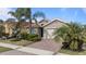 Single story house with a two-car garage, and palm trees at 11550 Blackfin St, Venice, FL 34292