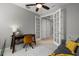 Home office with a wooden desk, comfy chair, and gray couch at 11550 Blackfin St, Venice, FL 34292
