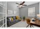 Relaxing home office with gray couch and wooden work desk at 11550 Blackfin St, Venice, FL 34292