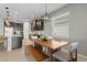 Modern kitchen with dark cabinetry, stainless steel appliances, and an island at 11550 Blackfin St, Venice, FL 34292