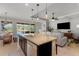 Open kitchen with island, granite countertops, and stainless steel appliances at 11550 Blackfin St, Venice, FL 34292