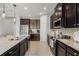 Modern kitchen with granite countertops and stainless steel appliances at 11550 Blackfin St, Venice, FL 34292