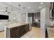 Open kitchen with island, granite countertops, and stainless steel appliances at 11550 Blackfin St, Venice, FL 34292