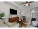 Relaxing living room, featuring a large TV, comfortable seating, and a coffee table at 11550 Blackfin St, Venice, FL 34292