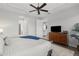 Spacious main bedroom with ceiling fan and wood dresser at 11550 Blackfin St, Venice, FL 34292