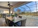 Covered patio with table and chairs overlooking the pool at 11550 Blackfin St, Venice, FL 34292
