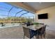 Enjoy this covered patio, pool and spa with lake views at 11550 Blackfin St, Venice, FL 34292