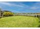 Spacious backyard with a picturesque lake view and a fence at 11786 Sistine Ln, Venice, FL 34293