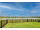 Spacious backyard with a lake view, and a black metal fence at 11786 Sistine Ln, Venice, FL 34293