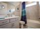 Guest bathroom with shower/tub combo, gray tile, and teal shower curtain at 11786 Sistine Ln, Venice, FL 34293