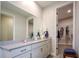 Bright bathroom boasts a large vanity with granite countertop and walk-in closet at 11786 Sistine Ln, Venice, FL 34293