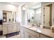Spacious bathroom features dual vanities, a large mirror, and a walk-in shower at 11786 Sistine Ln, Venice, FL 34293
