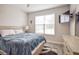 Bedroom with double bed, wooden dresser, and large window at 11786 Sistine Ln, Venice, FL 34293
