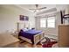 Serene bedroom with a ceiling fan, windows, and wall-mounted TV at 11786 Sistine Ln, Venice, FL 34293