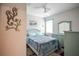 Light teal bedroom with double bed, ocean-themed decor, and built-in dresser at 11786 Sistine Ln, Venice, FL 34293