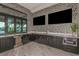 Community bar with dark cabinetry, wine cooler, and built-in microwave at 11786 Sistine Ln, Venice, FL 34293