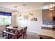 Bright dining area with a live-edge table and bench seating at 11786 Sistine Ln, Venice, FL 34293