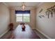 Elegant dining area featuring a live-edge wood table and decorative wall art at 11786 Sistine Ln, Venice, FL 34293