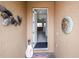Front entry with open door, revealing interior view, and coastal decor at 11786 Sistine Ln, Venice, FL 34293