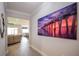 Entryway with large art piece and view into the living room at 11786 Sistine Ln, Venice, FL 34293
