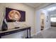 Entryway with console table, decorative art, and view to living area at 11786 Sistine Ln, Venice, FL 34293