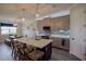 Modern kitchen with island, white countertops, and taupe cabinets at 11786 Sistine Ln, Venice, FL 34293