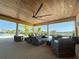 Relaxing outdoor lounge area with wicker furniture and ceiling fans at 11786 Sistine Ln, Venice, FL 34293