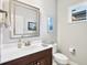 Powder room with vanity, toilet, and framed mirror at 12117 Whisper Lake Dr, Bradenton, FL 34211